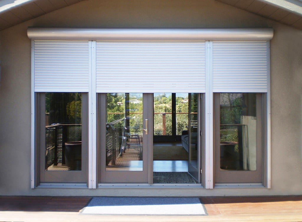 Electric roller shutters over patio doors